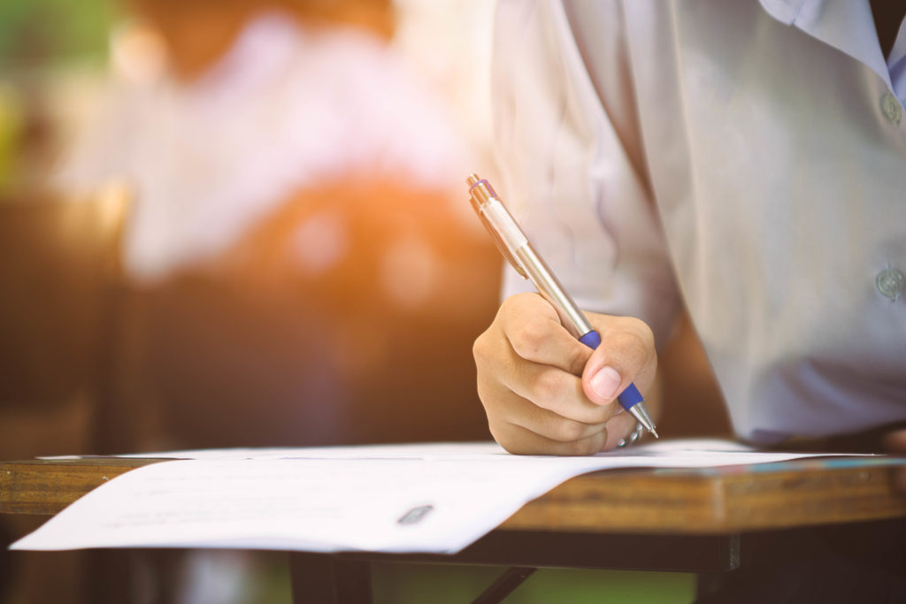 close-up shot of a woman taking an exam with a pen