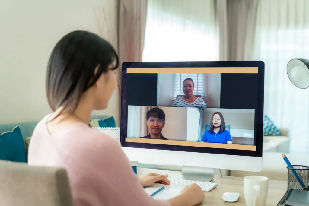 woman having a group video call in her home office